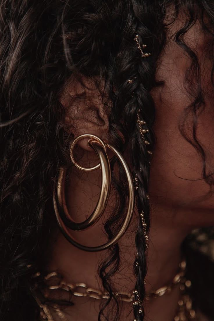 Braided hair with gold hoop earring and chain jewelry