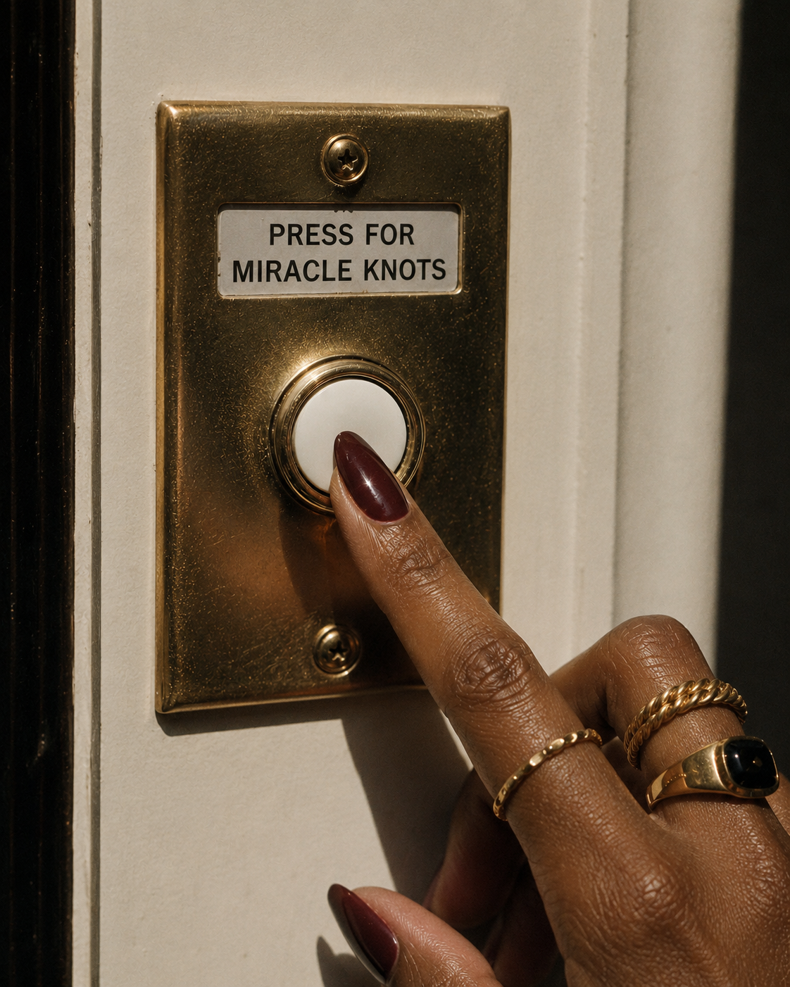 Brass doorbell reading Press for Miracle Knots